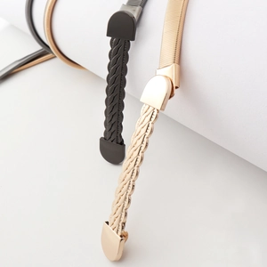 Detail of metal woven buckle texture on elastic spring waist belt for women