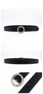 Detail of black leather belt for women featuring a round buckle with sparkling rhinestones