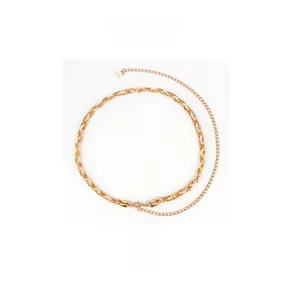 Detail of a golden braided waist chain with elegant imitation pearl and adjustable link