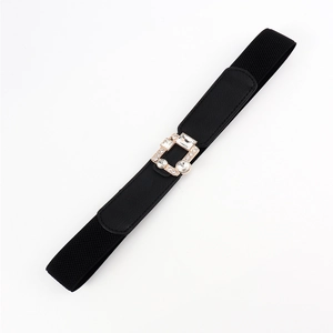 Detail view of square gold buckle with rhinestones on black elastic belt for dresses
