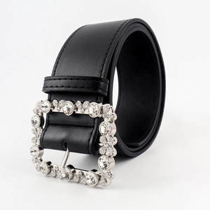 Close-up of black leather belt with square buckle encrusted in clear crystals