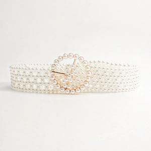 Detail of elegant six-row faux pearl belt with a round pearl-inlaid rose gold buckle