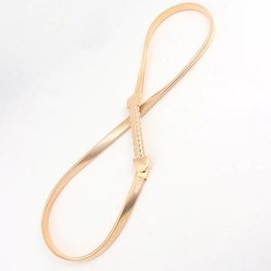 Detail view of gold-tone elastic metal waist chain with elegant twisted buckle closure