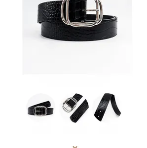 Detail view of black faux crocodile texture belt with silver double-ring metal buckle