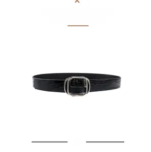 Close-up of black faux crocodile pattern leather belt with silver rectangular alloy buckle