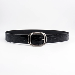 Close-up of black crocodile embossed leather belt with silver rectangular buckle