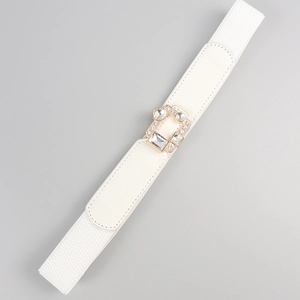 Detail of white elastic waist belt featuring a gold buckle with crystal rhinestones