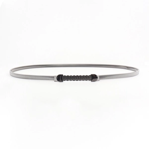 Detail of minimalist gunmetal elastic waist chain with wavy embossed buckle for dresses