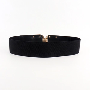 Detailed view of women's black elastic wide waist belt with golden metal buckle clasp