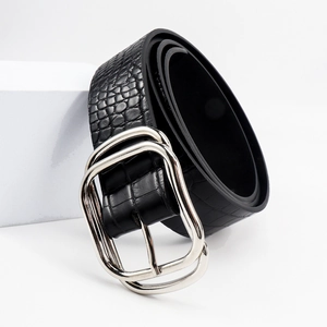 Detail of black faux crocodile skin belt with elegant silver double-ring buckle clasp