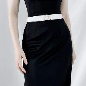 White elastic waist belt with sparkling rhinestone square buckle shown on a model