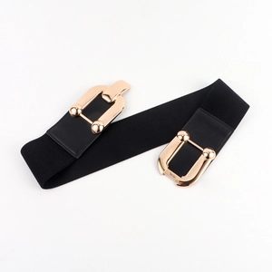 Detail of wide black elastic waist belt featuring a gold geometric interlocking buckle