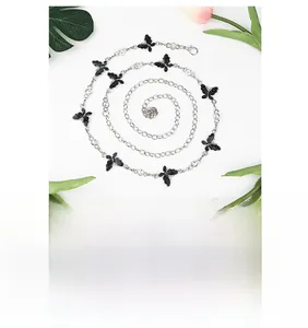 Detail of silver butterfly waist chain with sparkling rhinestones and rose pendant