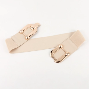 Close-up of cream elastic wide belt with a golden oval metal buckle for dresses