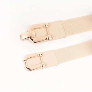 Detail of light gold buckle and elastic fabric texture on this wide women belt