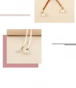 Detail of woven waist rope with pearl pendants and adjustable metal ends for women