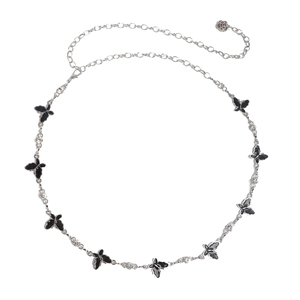 Detail of silver waist chain featuring black enamel butterflies and rose pendant charm