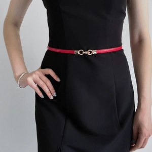 Fashionable red slim leather belt with gold double ring buckle on black dress