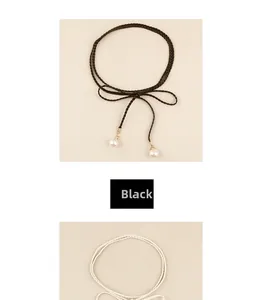 Detail of bohemian braided waist cords in black and beige with elegant pearl pendants