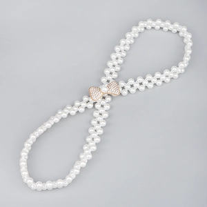 Vue détaillée de la chaîne de taille en perles à double rang avec nœud en strass rose doré