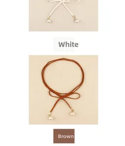 Detail of bohemian braided waist rope featuring elegant pearl pendants in white and brown