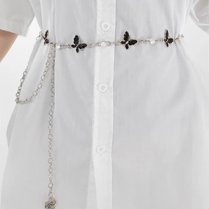 Detail of silver chain belt with black glitter butterfly charms and sparkling rhinestones