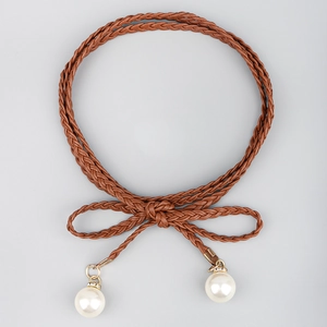 Detail of bohemian braided waist rope with knot and large faux pearl pendants