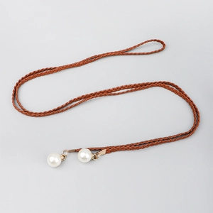 Close-up of woven bohemian brown waist rope featuring white pearl pendants and gold accents