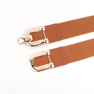 Detailed view of the brown elastic belt with its decorative light gold metallic buckle