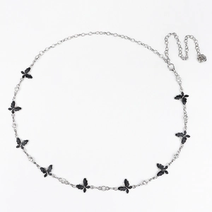 Detail of silver waist chain with black glitter butterflies and a rose charm pendant