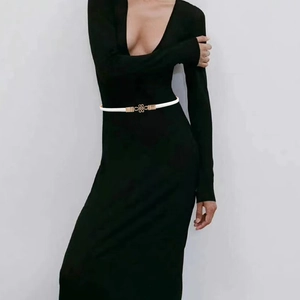 Slim white adjustable PU leather belt for women featuring a clover gold buckle on a black dress