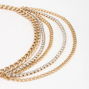 Détail de la ceinture chaîne dorée multicouche avec maillons cubains et strass brillants