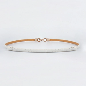 Detail of slim white leather belt with gold metal ring buckle and neat stitching