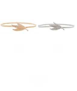 Close-up of gold and silver elastic leaf buckle belts for elegant dress styling
