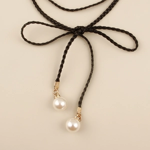 Detail of bohemian braided waist rope with white pearl pendants and crystal gold caps