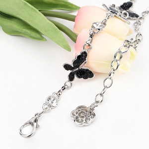 Silver chain waist belt featuring glitter butterfly, rose pendant, and crystal charms