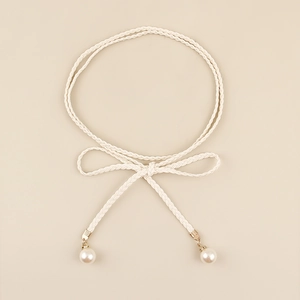 Detail of bohemian white braided waist rope with pearl pendants and gold metal clasps