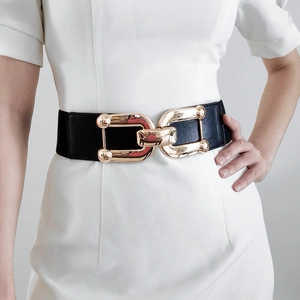 Close-up of interlocking gold metal buckle on a black wide elastic cinch belt
