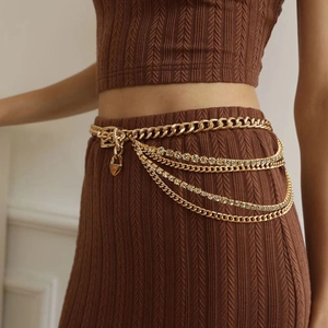 Elegant gold multi-layered waist chain with cuban links and sparkling heart locket