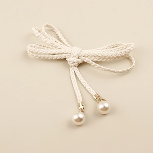 Detail of white woven waist rope belt featuring pearl pendants and bow knot design