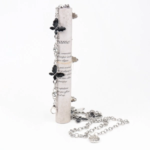 Macro detail of silver butterfly waist chain with sparkling rhinestones and rose pendant