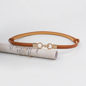 Close-up of brown slim leather belt featuring interlocking gold twisted metal buckle details
