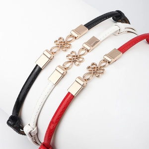 Elegant thin patent leather waist belts for women in black white and red with gold buckles