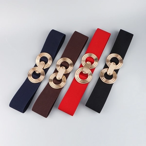 Detail view of elastic waist belts in four colors with decorative golden circle metal buckles