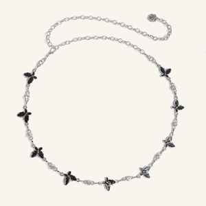 Detail of silver waist chain with black enamel butterflies, rhinestones, and rose pendant