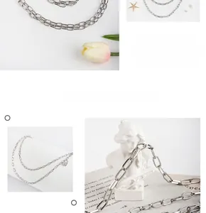 Detail showing multi-layer silver alloy waist chain with decorative padlock pendant