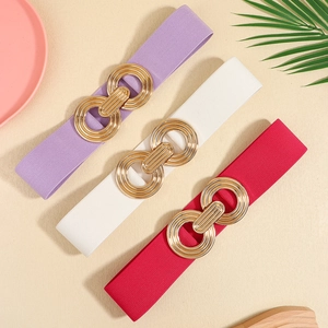 Close-up of interlocking gold rings on purple, white, and red elastic waist belts