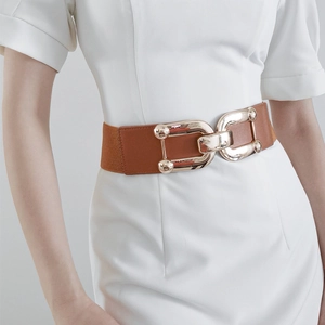 Detail of a brown leather elastic waist belt featuring a gold U-shaped metal buckle