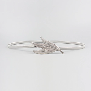 Detailed macro shot of a silver elastic metal waist chain with three-leaf decorative buckle