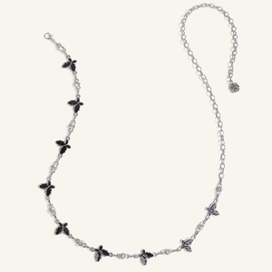 Detailed close-up of butterfly waist chain with rose pendant and sparkling rhinestones
